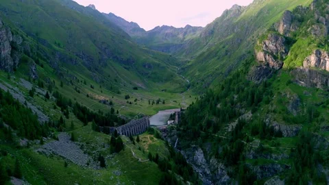 Dramatic sunset drone view looking down into the steep mountain gorge of Val di Stock Footage 342078422