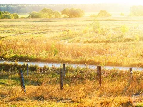 Dramatic sunset at farm meadow background Stock-Fotos