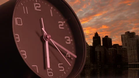 A Dramatic Sunset featuring an Alarm Clock positioned in a Vibrant Urban Stock Footage 294632983