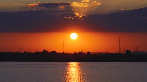 Dramatic sunset with flying birds over lake Stock Footage 136514499