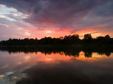 Dramatic sunset with gloomy clouds over the Sava River Stock Photos
