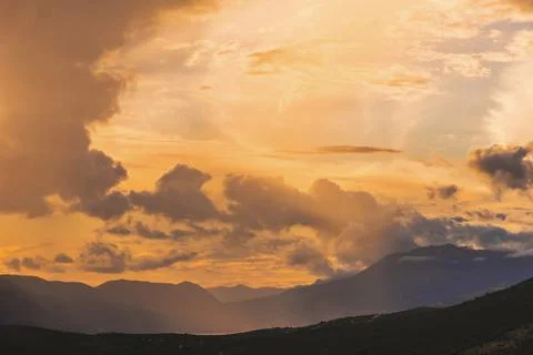 Dramatic Sunset with Glowing Sky over Mountains Stock Photos