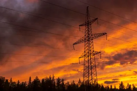A dramatic sunset glows on still clouds with smoke of forest fire 스톡 사진