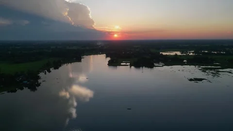 Dramatic sunset with huge storm cloud reflecting on rural lake water, aeria.. Video stock 344768517