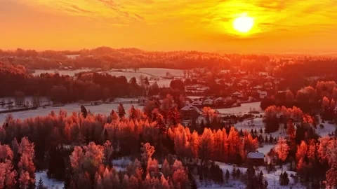 Dramatic Sunset Illuminated Over Snow-covered Rural Landscape With Remote Town 스톡 동영상 333800631