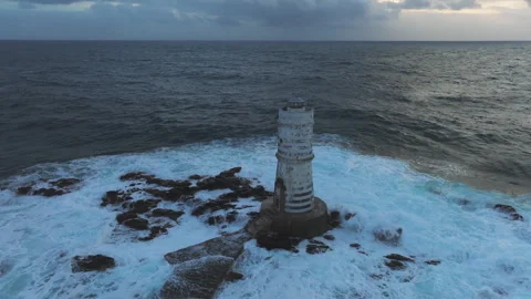 Dramatic sunset illuminating powerful waves striking rocky Mangiabarche Stock Footage 313291490