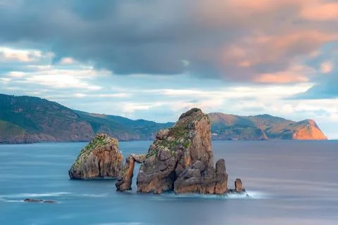 Dramatic sunset light on San Juan de Gaztelugatxe - Natural rock arch and f.. Stock Photos