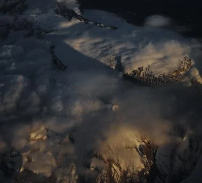 Dramatic Sunset Mountains Peaking Through Clouds, Swiss Alps Stock Photos