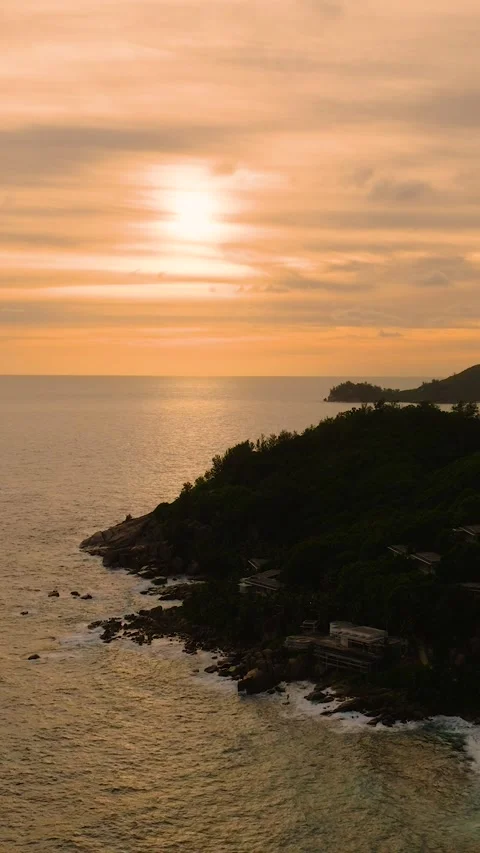 Dramatic sunset with ocean waves hitting the rocky coastline. Seychelles, Mahe. Stock Footage 303471553