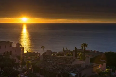 Dramatic sunset with orange colors, over some chalets in the area of Punta .. Foto stock