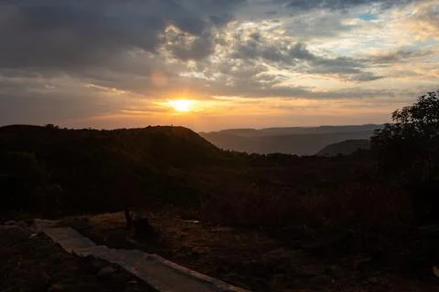 Dramatic sunset orange sky over mountain shadow at morning from flat angle 스톡 사진