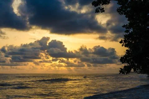Dramatic sunset over Atlantic ocean with cloudy sky at Limbe, Cameroon, Africa Stock Photos