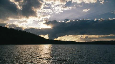 Dramatic Sunset Over Calm Lake and Wooded Hill, in sweden, smaland. Stock Photos