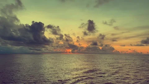 Dramatic sunset over a calm ocean with colorful clouds and reflections on t.. Stock Footage 338281496