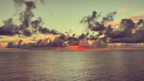 Dramatic sunset over calm ocean with colorful clouds and reflections on tra.. Stock Footage 338281949