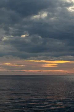 Dramatic Sunset Over Calm Ocean Waters Stock Photos