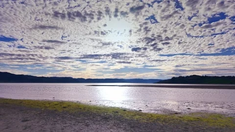 Dramatic sunset over calm sea waves and sandy beach with clouds Stock Footage 317946840