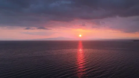 Dramatic Sunset Over Calm Sea With Dark Clouds and Red Reflection Stock-Footage 330637031