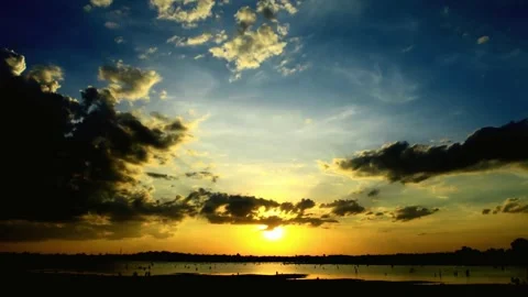 Dramatic Sunset over Calm Water with Dark Clouds Stock Footage 310923873