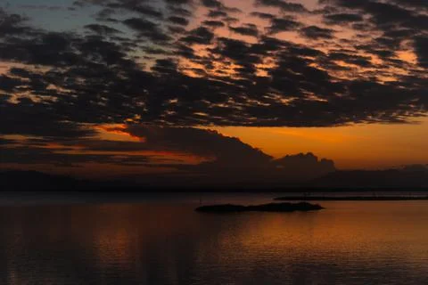 Dramatic Sunset Over Calm Water Фото