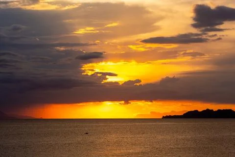 Dramatic Sunset Over Calm Water With Colorful Evening Sky Stock Photos