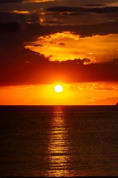 Dramatic Sunset Over Calm Water With Colorful Evening Sky Stock Photos