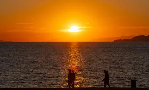 Dramatic Sunset Over Calm Water With Colorful Evening Sky Stock Photos