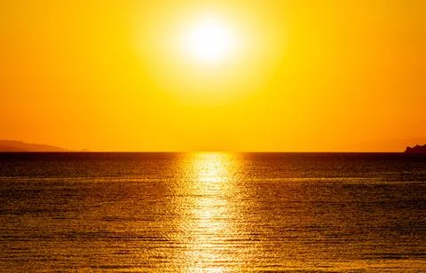 Dramatic Sunset Over Calm Water With Colorful Evening Sky Stock Photos