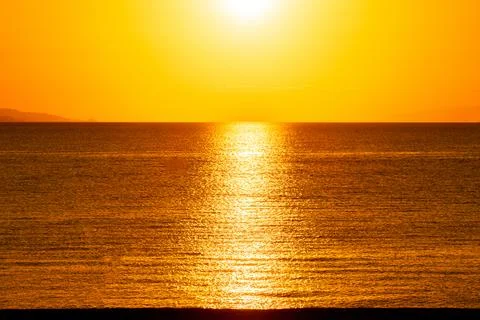 Dramatic Sunset Over Calm Water With Colorful Evening Sky Stock Photos