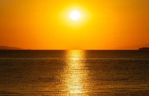 Dramatic Sunset Over Calm Water With Colorful Evening Sky Stock Photos