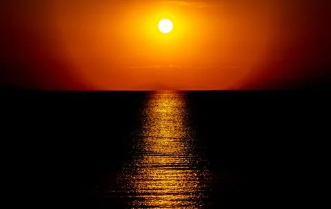 Dramatic Sunset Over Calm Water With Colorful Evening Sky Stock Photos