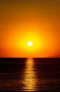 Dramatic Sunset Over Calm Water With Colorful Evening Sky Stock Photos