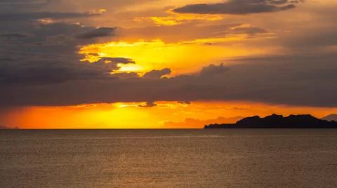 Dramatic Sunset Over Calm Water With Colorful Evening Sky Stock Photos
