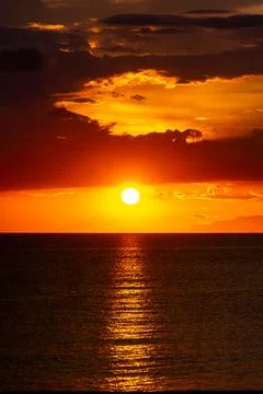 Dramatic Sunset Over Calm Water With Colorful Evening Sky Stock Photos