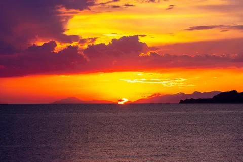 Dramatic Sunset Over Calm Water With Colorful Evening Sky Stock Photos