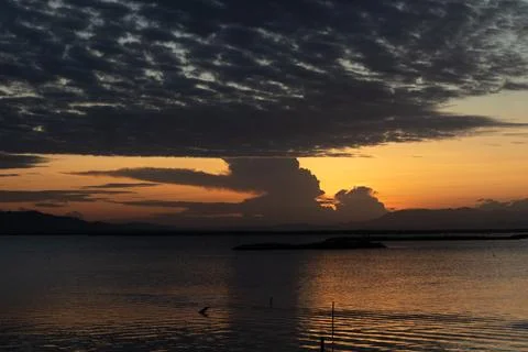 Dramatic Sunset Over Calm Water Stock Photos