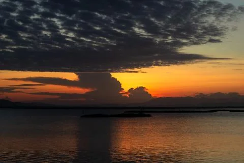 Dramatic Sunset Over Calm Water Fotos Stock