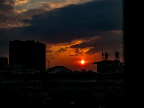 Dramatic sunset over city buildings silhouette, urban evening landscape and.. Fotos Stock