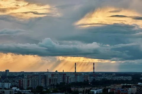 Dramatic Sunset Over City Skyline With Industrial Chimneys Stock Photos