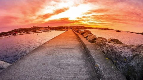 Dramatic Sunset over Coastal Breakwater Pathway 스톡 동영상 310244311