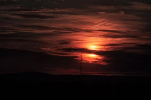 Dramatic sunset over a dark horizon Stock Photos