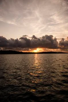 Dramatic Sunset Over Dark Sea With Dark Clouds Stock Photos