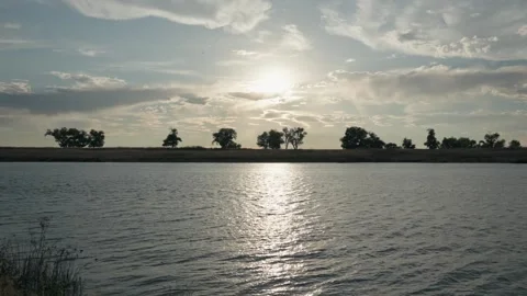 Dramatic Sunset Over a Deep Water Channel and Levee Landscape Stock Footage 318668689