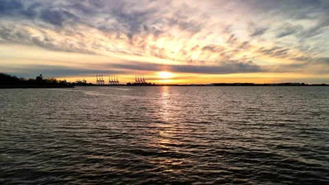 Dramatic sunset over the Elizabeth River industrial harbor and Norfolk Virginia  Stock Footage 329655154