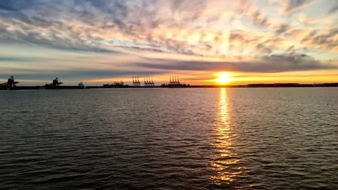 Dramatic sunset over the Elizabeth River industrial harbor and Norfolk Virginia  Stock Footage 329655162