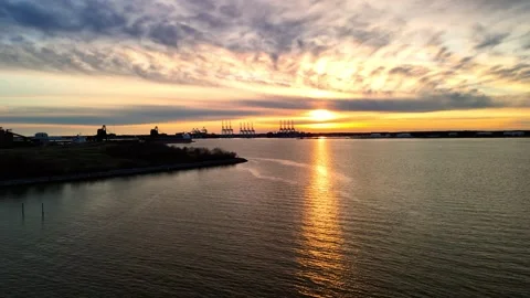 Dramatic sunset over the Elizabeth River industrial harbor and Norfolk Virginia  Stock Footage 329655165