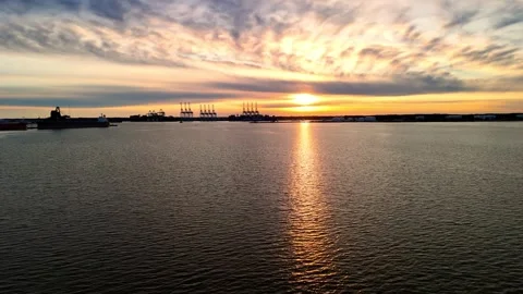 Dramatic sunset over the Elizabeth River industrial harbor and Norfolk Virginia  Stock Footage 329655169