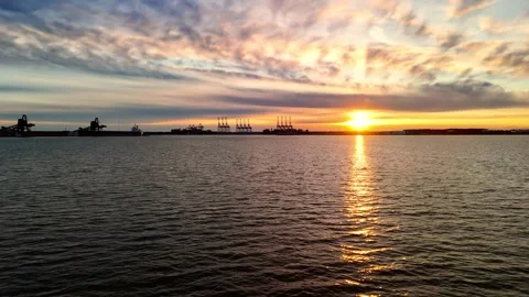 Dramatic sunset over the Elizabeth River industrial harbor and Norfolk Virginia  Stock Footage 329655171