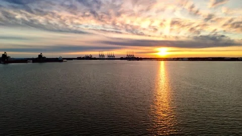 Dramatic sunset over the Elizabeth River industrial harbor and Norfolk Virginia  Stock Footage 329655180