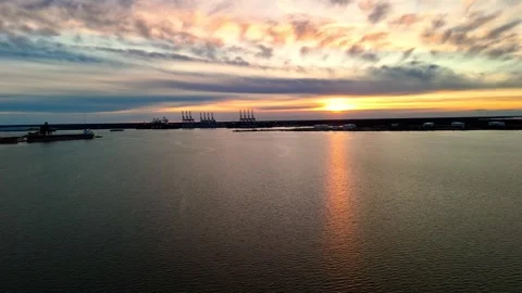 Dramatic sunset over the Elizabeth River industrial harbor and Norfolk Virginia Stock Footage 329655186